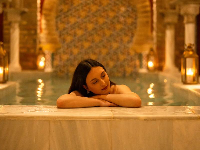 Warm pool under horseshoe arches at Hammam Palacio Nazarí