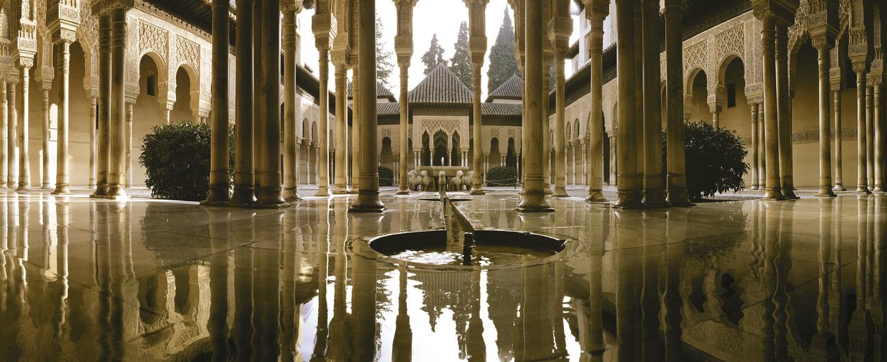 Court of the Lions reflected in water in the Nasrid Palaces of the Alhambra